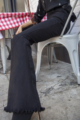 Women's Black High Rise, With Distinctive 70's Flare, Jeans With Frayed Edging Around The Bottom Of Each Jean Leg, Stretch Fabric & Button Front